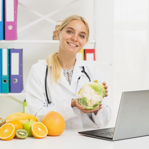medium-shot-smiley-doctor-with-laptop-cauliflower (1)